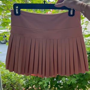 Gold Hinge peach pleated tennis skirt.